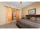 Comfortable main bedroom with ensuite bathroom featuring sliding wood doors, creating a private retreat at 5370 S Desert Dawn Dr # 50, Gold Canyon, AZ 85118