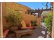 Private courtyard with pergola, potted plants and comfortable bench seating at 5370 S Desert Dawn Dr # 50, Gold Canyon, AZ 85118