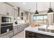 Modern kitchen features stainless steel appliances, gray cabinetry, and a large island with a sink at 544 E Amber Sun Dr, Phoenix, AZ 85086