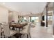 Open-concept dining and living area with modern furnishings, tile flooring, and a large sliding glass door at 544 E Amber Sun Dr, Phoenix, AZ 85086