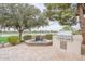 Backyard showcasing a built-in grill, water feature, lush greenery, and scenic views of the golf course at 623 E Peach Tree St, Queen Creek, AZ 85140