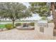 Backyard oasis with a water feature, built-in grill, and stunning views of the golf course and lake at 623 E Peach Tree St, Queen Creek, AZ 85140