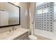 Clean bathroom features modern vanity, a large mirror, and a tiled shower-tub combination at 623 E Peach Tree St, Queen Creek, AZ 85140
