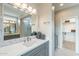 This bathroom features a double sink vanity with a white countertop, elegant fixtures, and a large mirror at 623 E Peach Tree St, Queen Creek, AZ 85140