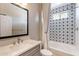 Bathroom showcasing a tub/shower with decorative tile, framed mirror, and vanity sink at 623 E Peach Tree St, Queen Creek, AZ 85140