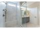 The bathroom has a glass-enclosed shower featuring stylish tile work and a modern showerhead, next to vanity at 623 E Peach Tree St, Queen Creek, AZ 85140