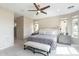 A stylish bedroom with a bench at the foot of the bed, complemented by elegant bedside tables and decor at 623 E Peach Tree St, Queen Creek, AZ 85140
