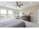 A bedroom with a lake view and a ceiling fan offers a tranquil retreat with ample natural light and neutral decor at 623 E Peach Tree St, Queen Creek, AZ 85140