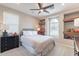 Bedroom showcasing neutral tones, built-in shelves, large window and dark wood furniture at 623 E Peach Tree St, Queen Creek, AZ 85140