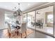 Elegant dining room with contemporary lighting fixtures, dark wood floors, and sliding glass doors to the patio at 623 E Peach Tree St, Queen Creek, AZ 85140