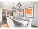 Stylish dining area with modern lighting and artwork, flowing seamlessly into the open kitchen space at 623 E Peach Tree St, Queen Creek, AZ 85140