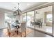 Dining room with modern light fixtures and glass sliding doors opening to outdoor space at 623 E Peach Tree St, Queen Creek, AZ 85140