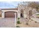 Charming single-story home with a two-car garage, desert landscaping, and a tiled roof at 623 E Peach Tree St, Queen Creek, AZ 85140