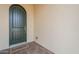 An elegant green front door with stone tile flooring and a welcome mat at 623 E Peach Tree St, Queen Creek, AZ 85140