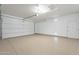 Spacious two car garage featuring epoxy flooring and an automatic door opener at 623 E Peach Tree St, Queen Creek, AZ 85140