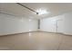 Spacious garage with epoxy flooring and ample storage, perfect for a workshop or parking multiple vehicles at 623 E Peach Tree St, Queen Creek, AZ 85140