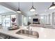 Open-concept kitchen with stainless steel appliances, center island with seating, and sightlines to the living room at 623 E Peach Tree St, Queen Creek, AZ 85140