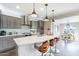 Modern kitchen with large island, gray cabinets, stainless steel appliances, and bar stool seating at 623 E Peach Tree St, Queen Creek, AZ 85140