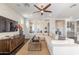 Bright living room with modern decor, comfortable seating, and a brick accent wall with a large screen TV at 623 E Peach Tree St, Queen Creek, AZ 85140