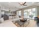 Open-concept living room with a view of the modern kitchen and patio through sliding glass doors at 623 E Peach Tree St, Queen Creek, AZ 85140