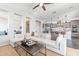 Spacious living room flowing into a modern kitchen with stainless steel appliances and a large island at 623 E Peach Tree St, Queen Creek, AZ 85140