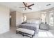 Cozy main bedroom featuring neutral tones, plush carpet, a ceiling fan and ensuite bathroom at 623 E Peach Tree St, Queen Creek, AZ 85140
