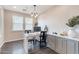 Well-lit office space with custom built-ins, a modern desk, and views from two large windows at 623 E Peach Tree St, Queen Creek, AZ 85140