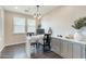 Home office features built-in desk and cabinets with drawers, and two windows at 623 E Peach Tree St, Queen Creek, AZ 85140