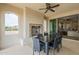 Covered patio featuring an outdoor fireplace and dining table, ideal for entertaining guests at 623 E Peach Tree St, Queen Creek, AZ 85140