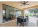 Covered patio offers seamless indoor/outdoor living with views of the golf course and water feature at 623 E Peach Tree St, Queen Creek, AZ 85140