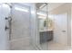 Bathroom with a glass-enclosed shower, marble tile, a shower bench and stylish vanity at 623 E Peach Tree St, Queen Creek, AZ 85140