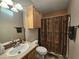 Standard bathroom featuring a vanity with sink, toilet, cabinet, and shower with patterned curtain at 650 N Hawes Rd # 4406, Mesa, AZ 85207