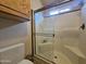 Bathroom features a glass enclosed shower with a built-in seat and toiletry shelving at 650 N Hawes Rd # 4406, Mesa, AZ 85207