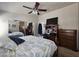 Bedroom boasts a ceiling fan, mirrored closet, and built-in shelving unit at 650 N Hawes Rd # 4406, Mesa, AZ 85207