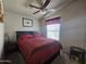 Comfortable bedroom with a ceiling fan, window, and queen-size bed at 650 N Hawes Rd # 4406, Mesa, AZ 85207
