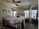 Bedroom with a wrought iron bed frame, ceiling fan, and serene natural light at 650 N Hawes Rd # 4406, Mesa, AZ 85207