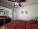 Comfortable bedroom with a mirrored closet, ceiling fan, and southwestern decor at 650 N Hawes Rd # 4406, Mesa, AZ 85207