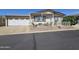 Inviting exterior with covered porch, stylish railings, and a connected garage at 650 N Hawes Rd # 4406, Mesa, AZ 85207