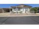 Charming home with an inviting front porch and well-maintained landscaping at 650 N Hawes Rd # 4406, Mesa, AZ 85207