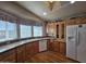 Bright kitchen with wood cabinets, wood laminate floors, and window above the sink at 650 N Hawes Rd # 4406, Mesa, AZ 85207