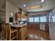 Bright kitchen with wood floors, island, and ample counter space and cabinets at 650 N Hawes Rd # 4406, Mesa, AZ 85207