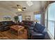 Spacious living room with comfortable leather sofas, ceiling fan, and natural lighting at 650 N Hawes Rd # 4406, Mesa, AZ 85207