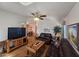 Cozy living room featuring hardwood floors, ceiling fan, and comfortable leather furniture at 650 N Hawes Rd # 4406, Mesa, AZ 85207