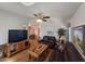 Cozy living room with dark leather sofas and a ceiling fan at 650 N Hawes Rd # 4406, Mesa, AZ 85207