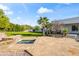 Expansive backyard featuring an in-ground pool, spa, manicured lawn, mature trees, and desert landscaping at 6700 E Caron Dr, Paradise Valley, AZ 85253