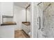 Bathroom with tiled shower, granite countertop, decorative mirror and storage at 6700 E Caron Dr, Paradise Valley, AZ 85253