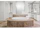 Luxurious bathroom with a jacuzzi tub, tiled floors, and elegant vanity at 6700 E Caron Dr, Paradise Valley, AZ 85253