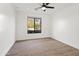 Minimalist bedroom featuring wood floors, ceiling fan, recessed lighting, and view to the yard at 6700 E Caron Dr, Paradise Valley, AZ 85253