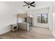 Bright bedroom with wooden floors, fan, and a wooden bunk bed with ladder, providing a cozy space at 6700 E Caron Dr, Paradise Valley, AZ 85253