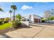 Elegant home featuring a large driveway, two-car garage, lush greenery and a well maintained yard with palm trees at 6700 E Caron Dr, Paradise Valley, AZ 85253